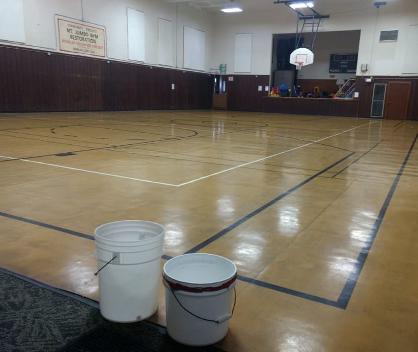 Buckets catch water from a roof leak inside the Mt. Jumbo Gym in Douglas on Wednesday.