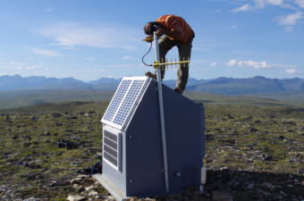 Field engineer Scott Dalton adjusts a radio communications link at a seismic station south of Cantwell.