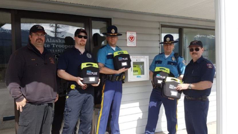 Members of the NTVFD and Alaska State Troopers installing AEDs.