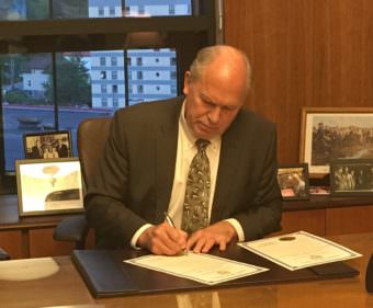 Gov. Bill Walker signs a proclamation for a special session focused on the budget and long-term spending plan, after lawmakers failed to compromise. May 17, 2017. (Photo by Andrew Kitchenman/KTOO/Alaska Public Media)