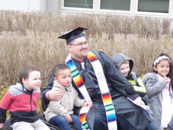 Marcos Galindo poses with children after his graduation from the University of Alaska Southeast on May 7, 2017 at the Charles Gamble Jr. -Donald Sperl Joint Use Facility.