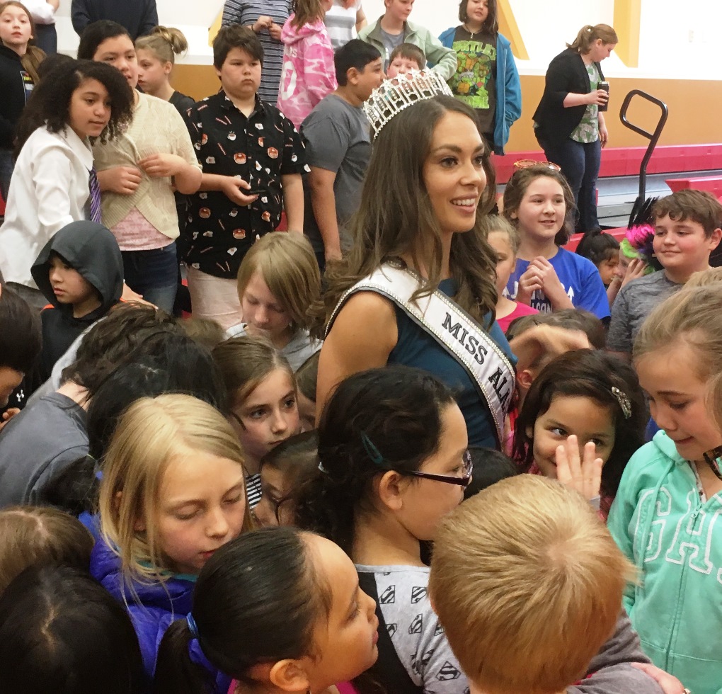 Miss Alaska USA Alyssa London stands for a group photo with students at Fawn Mountain Elementary School. (Photo by Leila Kheiry/KRBD)