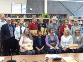 The Juneau School Board poses with a group of retiring teachers and staff members on Tuesday.