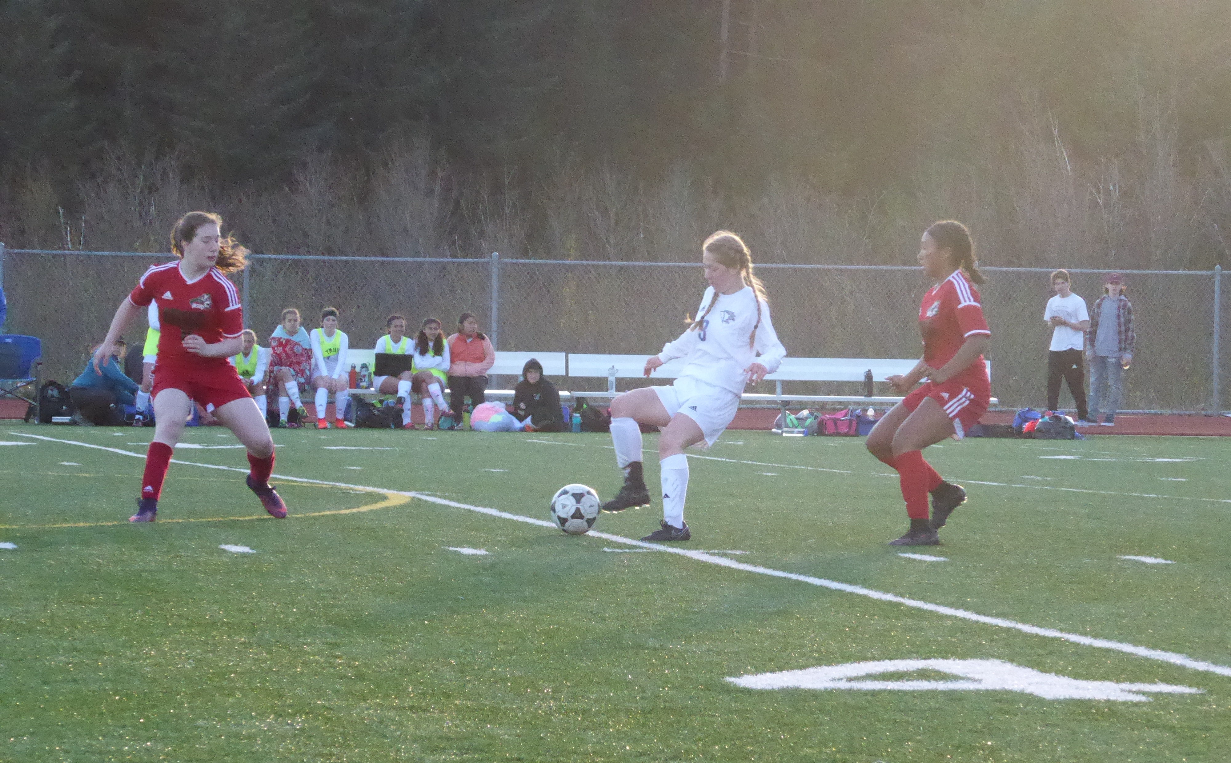 A Thunder Mountain soccer player tries to move past two Juneau-Douglas players.