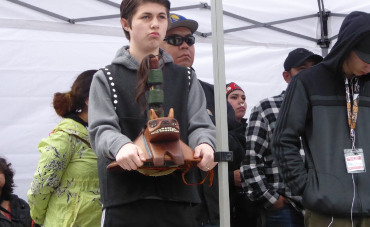 Boy holding a carving at Saturday's ceremony.