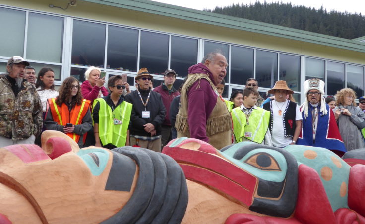David Katzeek explains the significance of one of the faces on the totem pole at Saturday's ceremony.