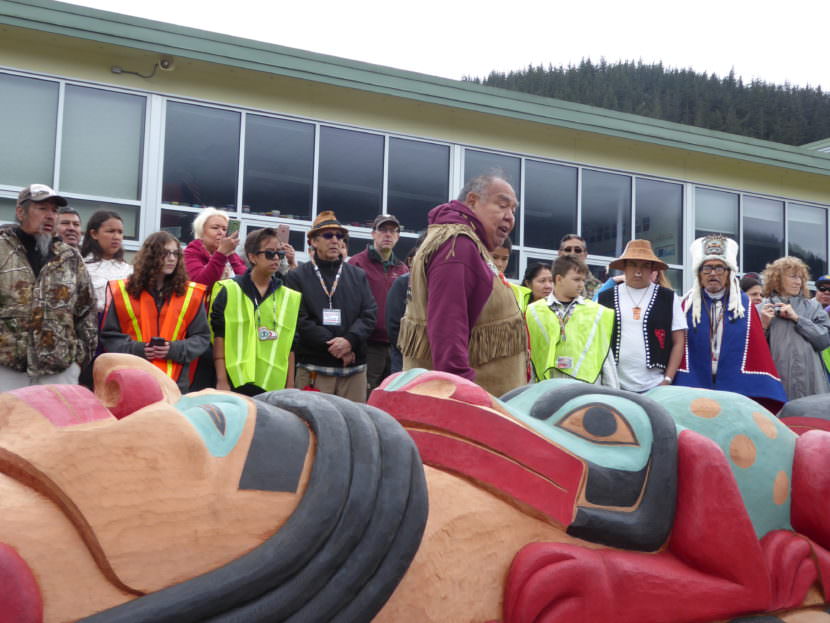 David Katzeek explains the significance of one of the faces on the totem pole at Saturday's ceremony.