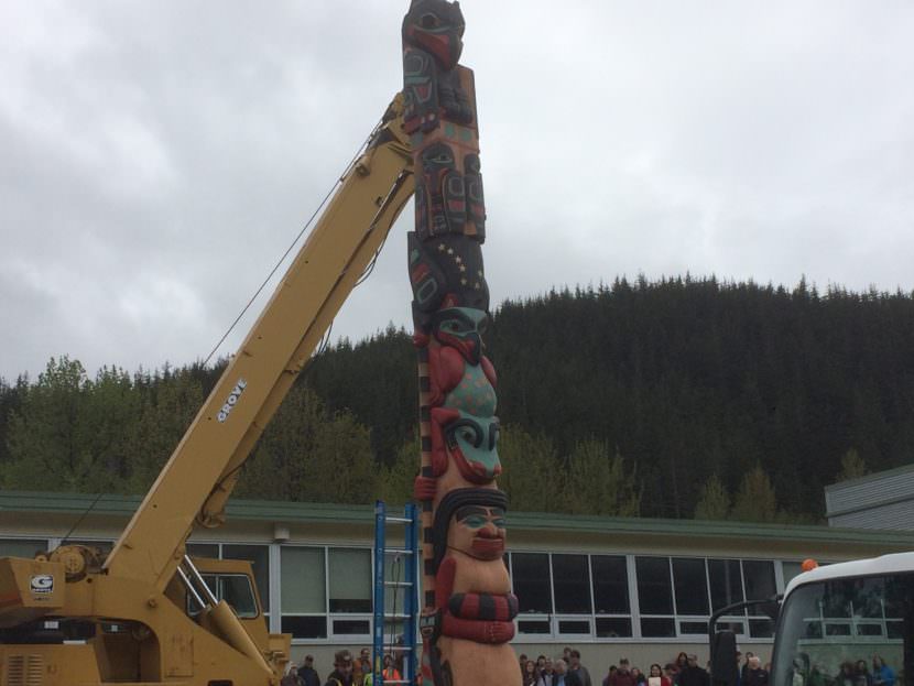 The Raven totem pole after being placed on its base on Saturday.