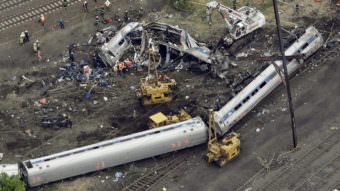 Emergency personnel work at the scene of a deadly Amtrak derailment in Philadelphia in 2015. The engineer has been charged with crimes including involuntary manslaughter.