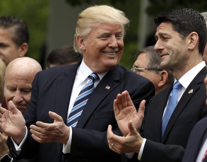 President Donald Trump celebrates with House Speaker Paul Ryan in the White House Rose Garden Thursday after the House voted to pass the American Health Care Act.