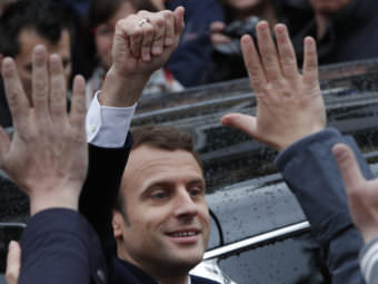 French independent centrist presidential candidate Emmanuel Macron waves as he leaves the polling station after casting his ballot in the presidential election in Le Touquet, France, Sunday. Macron was declared the winner based on early vote counts by the French Interior Ministry.