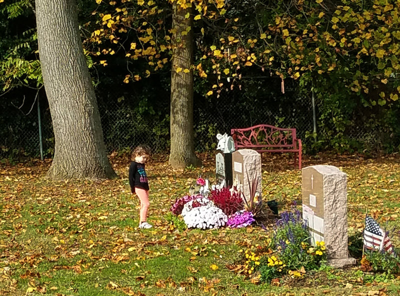 Hailey, now 5, at her mother's grave.