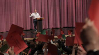 Red cards, signaling disagreement, often predominated at Sen. Dan Sullivan’s town hall May 20 in Anchorage. (Photo by Wesley Early/Alaska Public Media)
