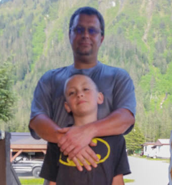 Shaun Stewart poses with his son at his home in Juneau on May 29, 2017.