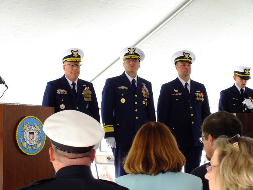Vice Adm. Fred Midgette, commander of the Coast Guard's Pacific area (left), Rear Adm. Michael McAllister, commander of the Coast Guard's 17th District (center), and Lt. Frank Reed, commanding officer of the cutter Bailey Barco, prepare to speak during a commissioning ceremony in Juneau on June 14, 2017.