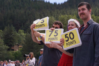 From left to right, judges Kevin Bornemann, Kristie Ely and Ethan Hubbard raise signs to award points in the Super Dog Frisbee Contest in Douglas on July 4, 2016.