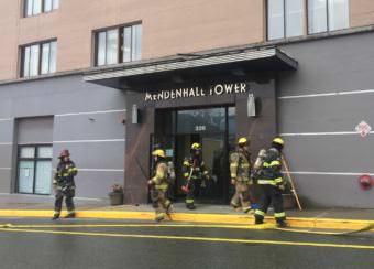 Firefighters respond to reports of smoke at the Mendenhall Tower Apartments in downtown Juneau on Monday, June 19, 2017. Officials had evacuated the building as a precaution, but couldn't find what caused the smoke.