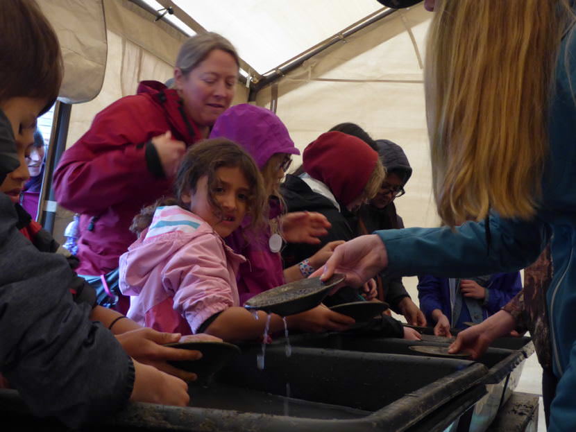 A group of children try their hand at gold panning at Juneau Gold Rush Days on Saturday.
