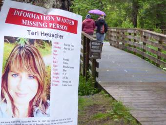 A flyer posted on Monday, June 26, 2017, at the Under Thunder trailhead off Jennifer Drive in the Mendenhall Valley states that Teri Heuscher is missing. The 53-year-old Juneau woman's vehicle was found there Saturday, June 24, 2017. (Photo by Quinton Chandler/KTOO)