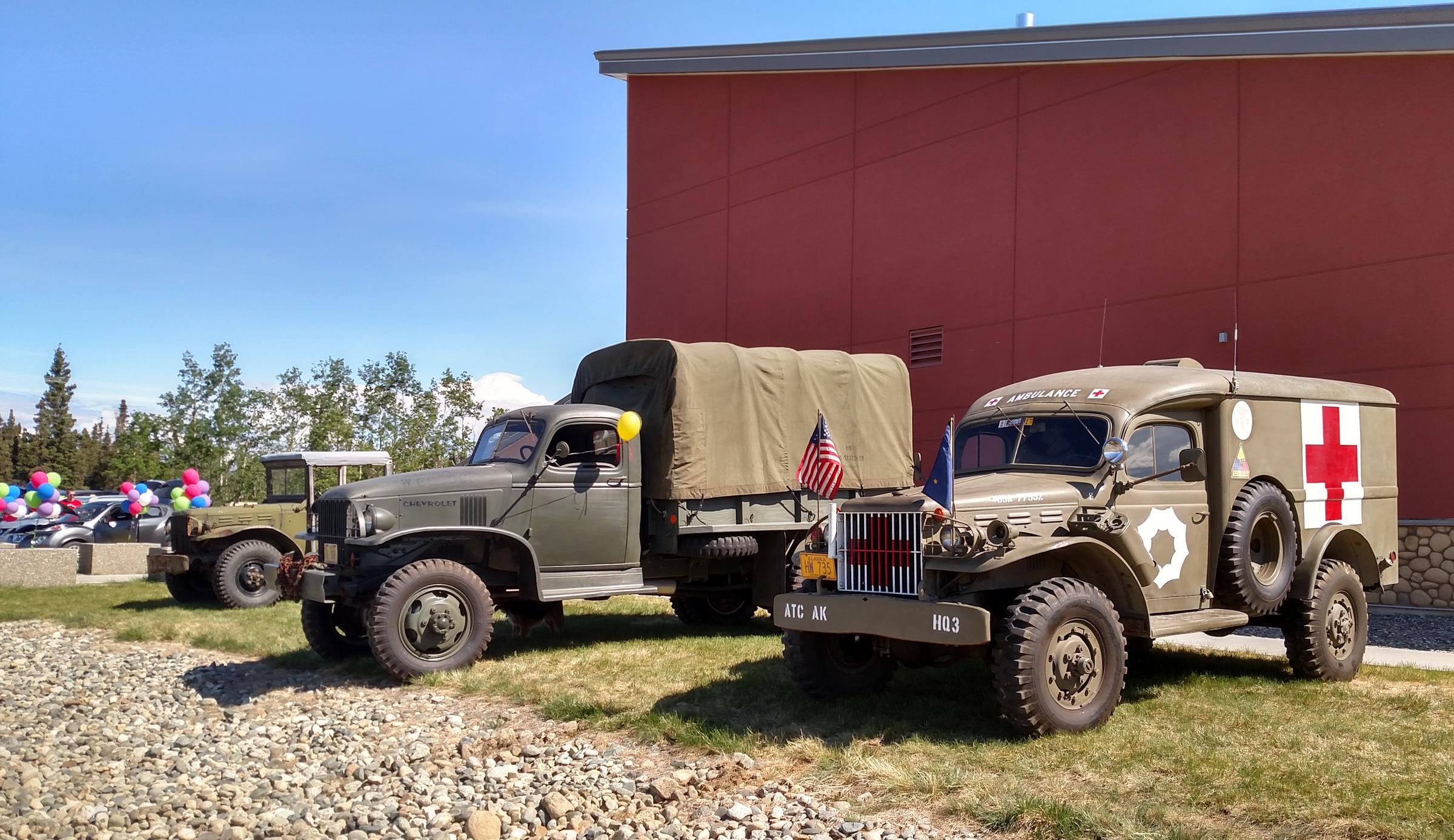 Owners of World War II-era Army trucks from Delta, Fairbanks and Anchorage brought their rigs and parked them in front of Fort Greely's Community Activity Center, where Saturday's ceremony was held, to lend an historically appropriate feel to the event. (Photo by Tim Ellis/KUAC)