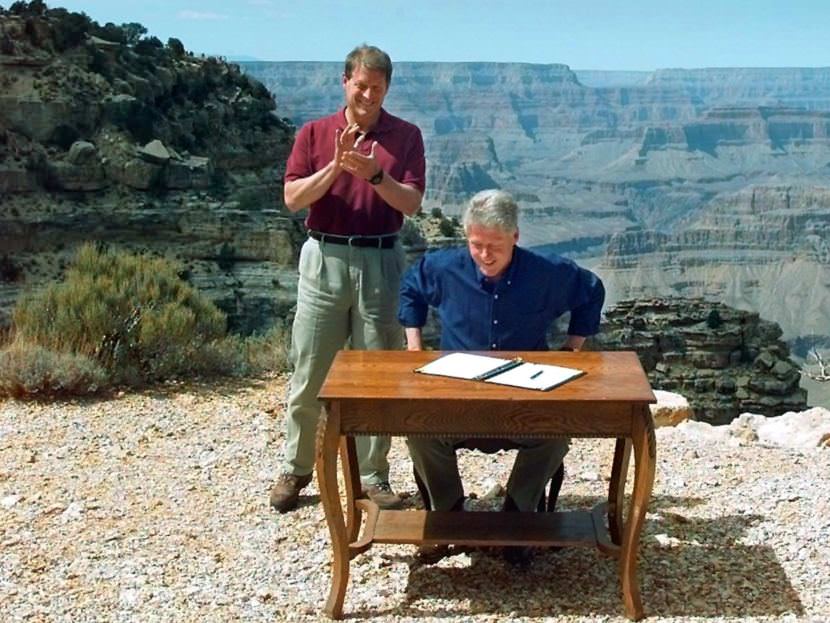 President Bill Clinton, with Vice President Al Gore, signs his 1996 order designating the Grand Staircase-Escalante National Monument in Utah. Opponents continue to note that Clinton made this move while sitting at the Grand Canyon — in Arizona. Doug Mills/AP
