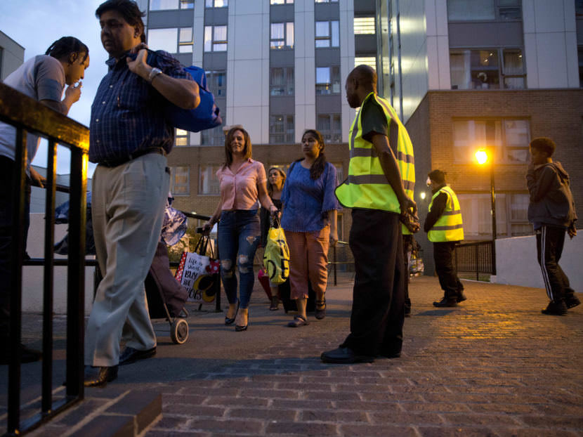Officials evacuate residents of the Chalcots Estate, in London's Camden borough on Friday evening. Camden's local council decided to evacuate the hundreds of households due to safety concerns following the devastating fire that killed 79 people in Grenfell Tower.