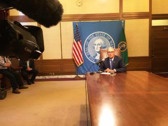 Washington Gov. Jay Inslee speaks with reporters Tuesday after a bill signing. At the time there was no budget agreement and he said that was creating "considerable anxiety" as a government shutdown loomed. (Photo by Austin Jenkins/Northwest News Network)