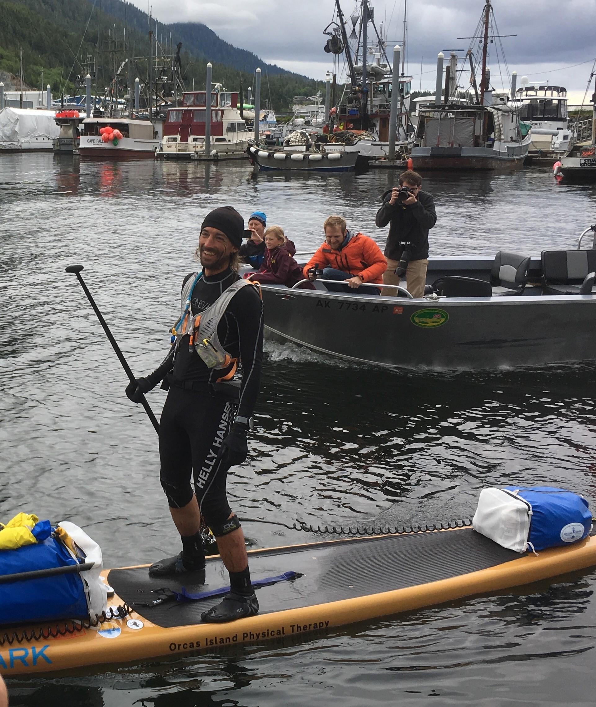 Karl Kruger arrived at Thomas Basin Boat Harbor in Ketchikan Sunday evening, becoming the first SUP finisher of the Race to Alaska. (Photo by Leila Kheiry/KRBD)