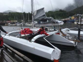 Chris Burd laughs as his brothers tie up their boat in Ketchikan after winning the 2017 Race to Alaska. (Photo by Leila Kheiry/KRBD)