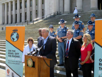 Washington Gov. Jay Inslee discusses a new distracted driving law on the state Capitol steps Monday, July 17, 2017.