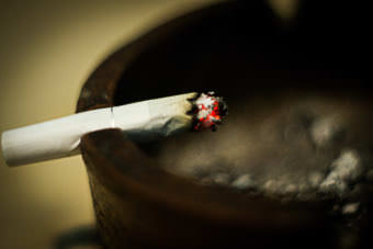 Cigarette burning over an ash tray.