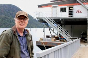 Pat Glaab stands in front of the Northline barge he is converting into a mobile fish processor.