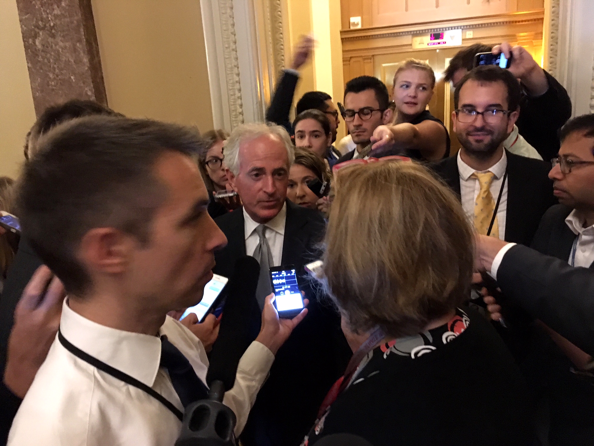 U.S. Sen. Bob Corker, R-Tennessee, at the center of one media scrum outside the Senate chamber. (Photo by Liz Ruskin/Alaska Public Media)