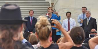 Sen. Elizabeth Warren, D-Massachusetts, addresses a crowd outside the U.S. Capitol in Washington protesting the Republican health care bill on July 25, 2017.