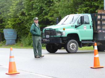 District Ranger Brad Orr standing behind the barricade blocking the Mendenhall Glacier Recreation Area to traffic.