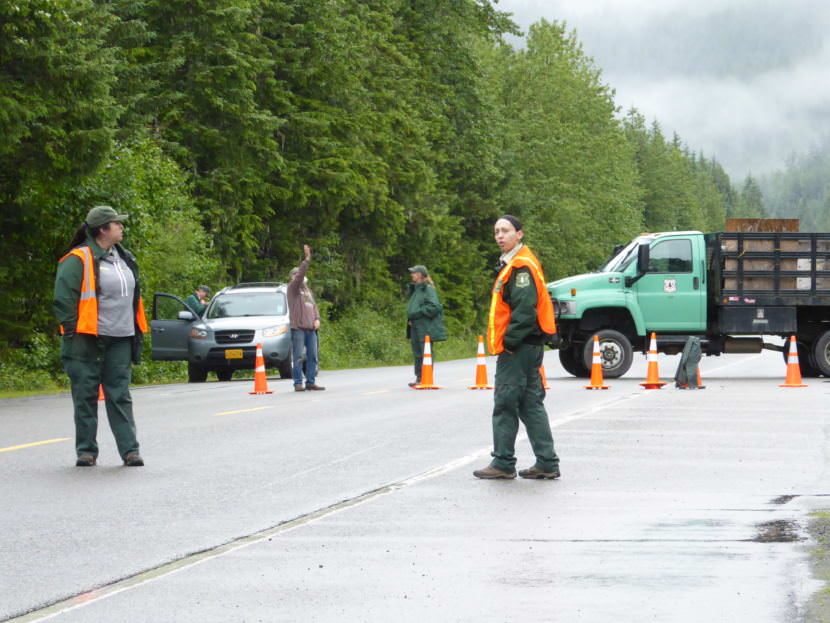 Forest Service employees stand ready to turn visitors away from the Mendenhall Glacier Recreation Center on Sunday.
