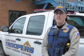 Alaska Wildlife Trooper Jake Abbott stands in front of the Alaska State Trooper post in Juneau.