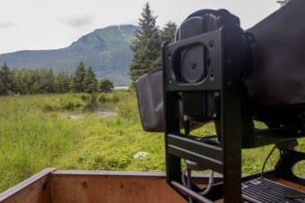 A robotic camera provides for wildlife tracking across a meadow near the Mendenhall Glacier Visitors Center for Wild Alaska Live. (Photo by Mikko Wilson/KTOO)