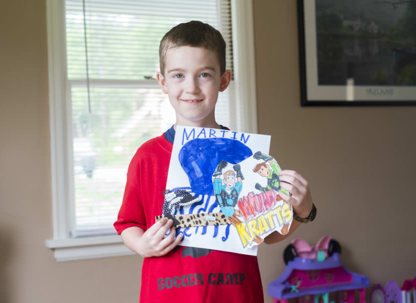 7-year-old Charlie Begenyi holds gifts for the Kratt brothers. (Photo by Annie Bartholomew/KTOO)