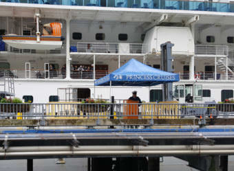 Passengers wait aboard the Emerald Princess moored on the South Franklin Street Dock in Juneau on Wednesday, July 27, 2017. The FBI investigated an alleged murder after a Utah woman died the day before on the ship.