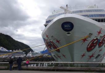 The Norwegian Pearl tied up at Skagway’s Broadway dock in July 2017. Two more cruise ships are moored at the railroad dock in the background. (Photo by Emily Files/KHNS)