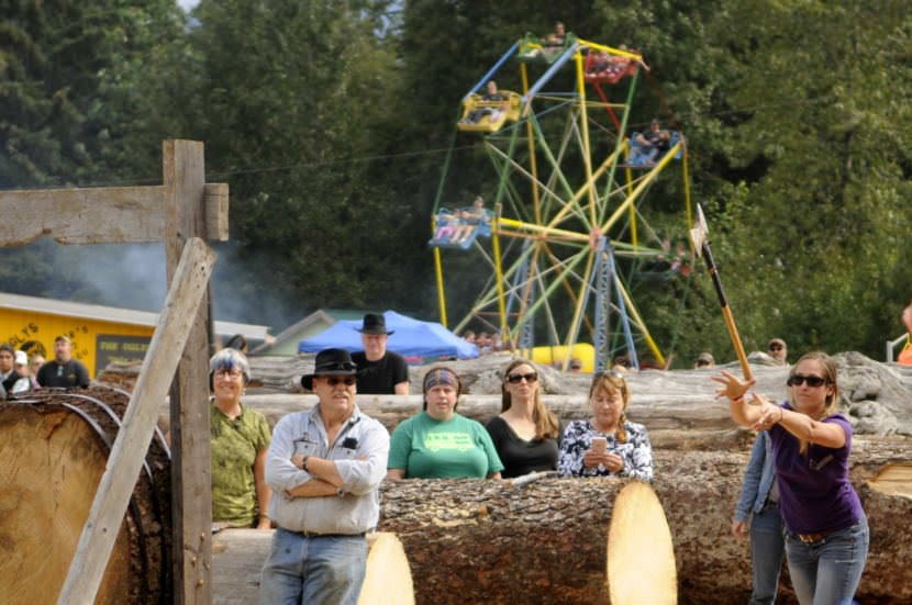 A woman competes in the axe throwing contest during the logging show at the 2016 Southeast Alaska State Fair. (Photo by Jillian Rogers/KHNS)