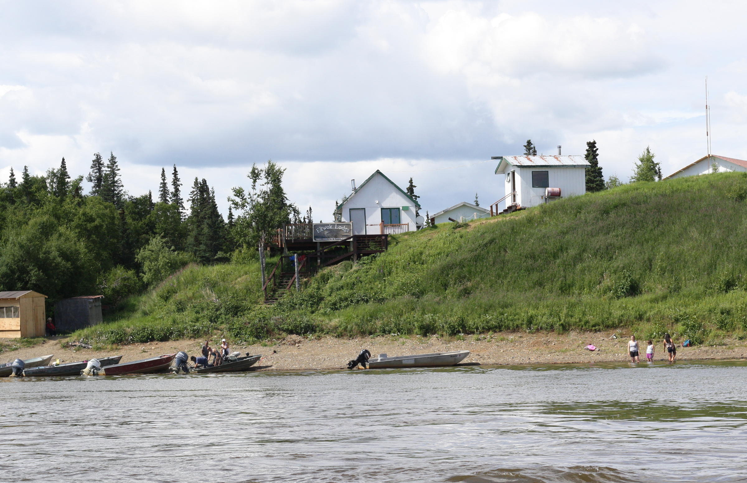 The Ekwok community arrives for a wellness camp graduation ceremony Friday. Ekwok Lodge, hosted the 30-day camp, where participants fought alcohol and drug addition with fishing and berry picking. (Photo by Avery Lill/KDLG)