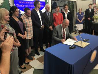 Gov. Bill Walker on Tuesday signed into law House Bill 159, which aims to help prevent opioid addiction before it starts. (Photo by Casey Grove/Alaska Public Media)