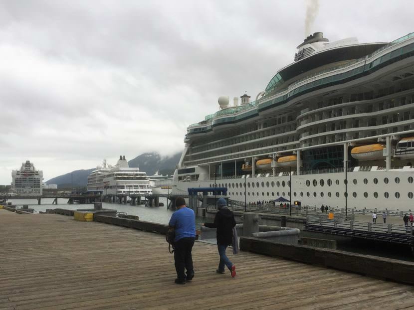 Passengers walk a downtown Juneau dock where three cruise ships are tied up June 11, 2017. (Photo by Ed Schoenfeld/CoastAlaska News)