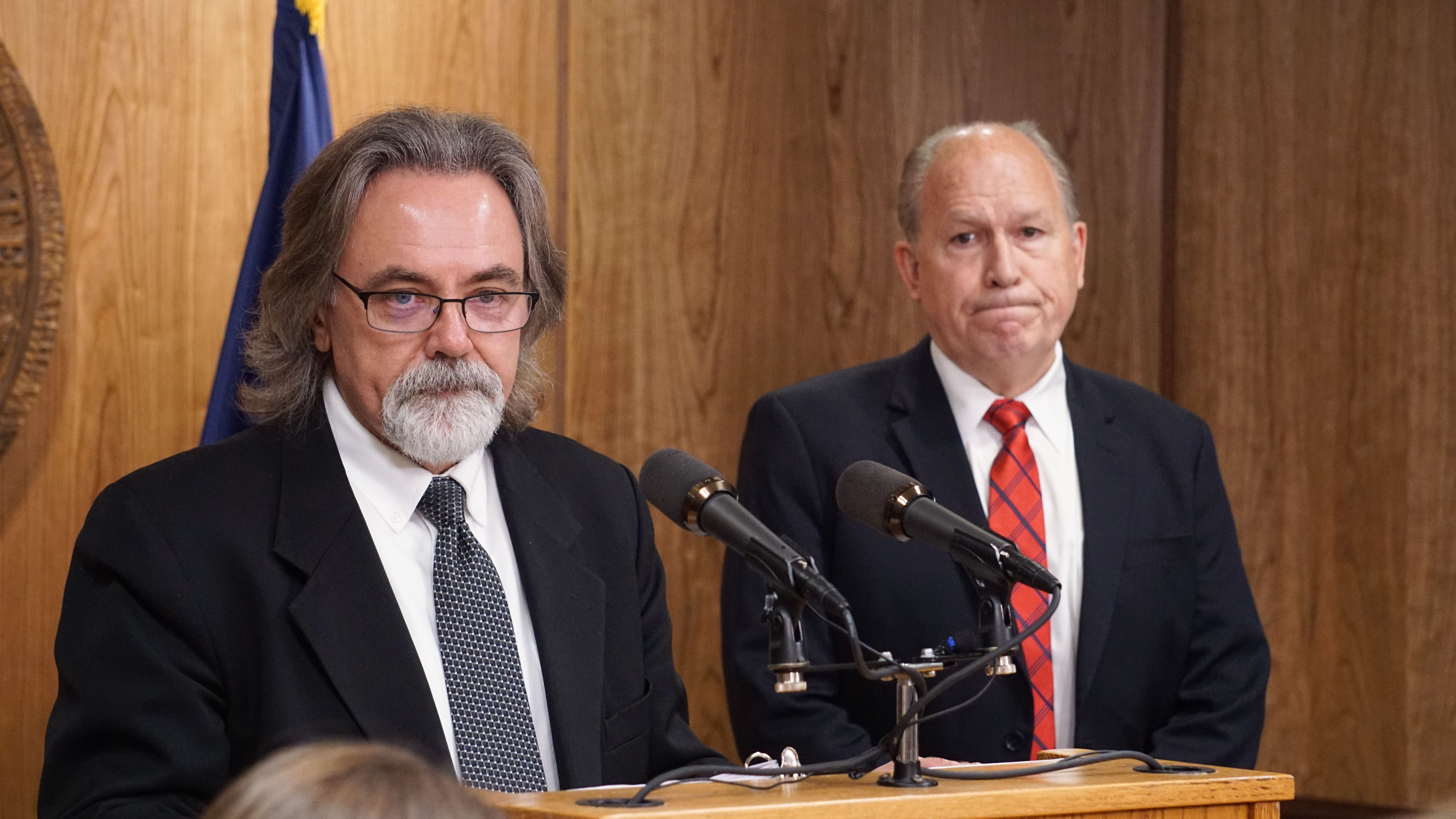 Department of Revenue Commissioner Randall Hoffbeck discusses a compromise budget package with reporters as Gov. Bill Walker listens in the cabinet room of the Capitol in Juneau on June 6, 2017. (Photo by Jeremy Hsieh/KTOO)