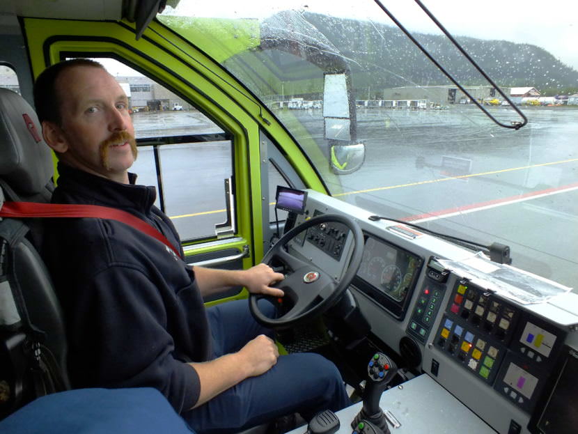Firefighter Craig Brown in the cab of A-1, Capital City Fire/Rescue's newest Airport Rescue Firefighting (ARFF) vehicle, looks for aircraft traffic before proceeding along the 'zipper line,' special lanes for vehicle traffic at the Juneau International Airport.