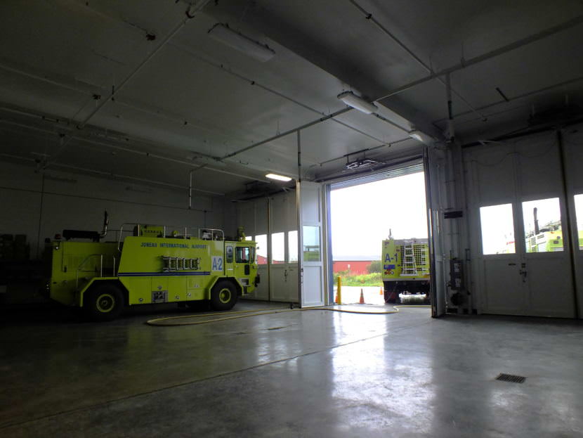 Two of Capital City Fire/Rescue's Airport Rescue Firefighting (ARFF) vehicles stand by inside and just outside of the Glacier Valley Fire Station's expanded ARFF vehicle bay.
