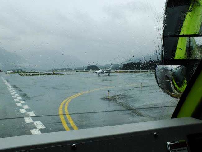 View from an inside of an ARFF vehicle as a Harris Air aircraft taxis off the runway to the ramp at Juneau International Airport.