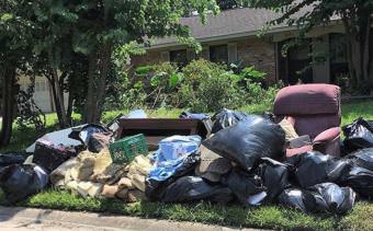 Ruined furniture and other trash pile up on the curb in Houston's Braeburn Glen neighborhood, where Sophi Zimmerman and her family live. Flooding destroyed furnishings, floors and household items. "Here's how it looks in front of every house on our block," Zimmerman said. (Photo courtesy Sophi Zimmerman)